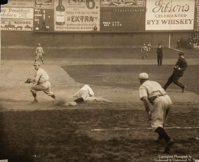 Bert Niehoff of Phillies slides into 3rd as the throw gets away from Larry Gardner of the Red Sox, at the Baker Bowl, Game 5 of the 1915 World Series, Oct 13, 1915.