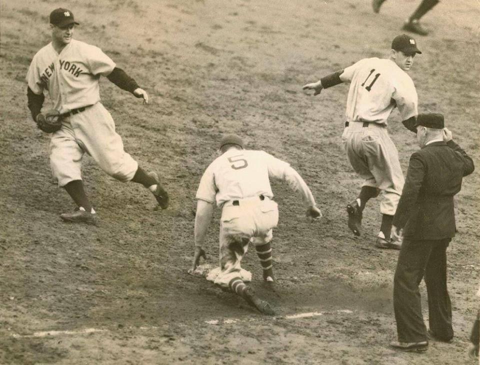 New York Yankees pitcher Lefty Gomez knocks in the winning run in the 4 – 2 clincher in Game 5 against the New York Giants