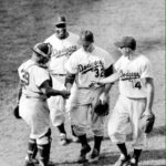 Sandy Koufax, in his second big league start, two-hits the Reds at Ebbets Field, 7-0. The 19 year-old bonus baby, displaying the dominance that he will feature during the 1960's, goes the distance, striking out 14 Cincinnati batters.