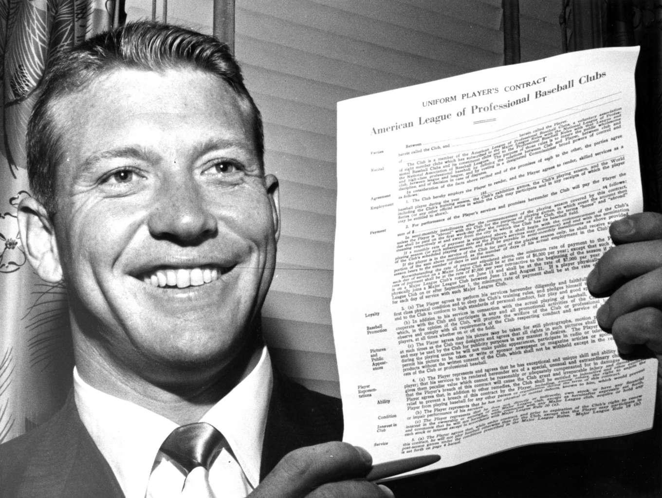 Mickey Mantle of the New York Yankees ends his holdout after one day.