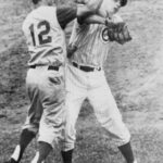 Believing that Chicago's Jim Brewer is throwing at him, Reds 2B Billy Martin throws his bat toward the mound. Then, he advances to retrieve it from Brewer, who has picked it up. The two exchange words and Martin launches a hard overhand right that fractures the orbital bone of Brewer's right eye. Both benches empty and Martin continues swinging, decking Frank Thomas. Brewer requires surgery and will be out of action for a month. The Cubs win, 5 - 3, on Ernie Banks' homer. Martin will be fined $500 for the punch and Brewer and the Cubs will sue the combative infielder on August 22 for $1,000,000. Years later, when the courts award Brewer $100,000, Martin's comment will be, "How can they ever collect it? I haven't got that kind of money,"