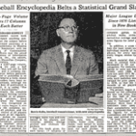 At a press conference, Commissioner Bowie Kuhn announces the publication of The Baseball Encyclopedia and holds up a copy of the 6 1/2 pound book.