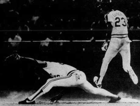 Fredbird, the mascot of the St. Louis Cardinals, tackles Enos Cabell in pre-game warmups