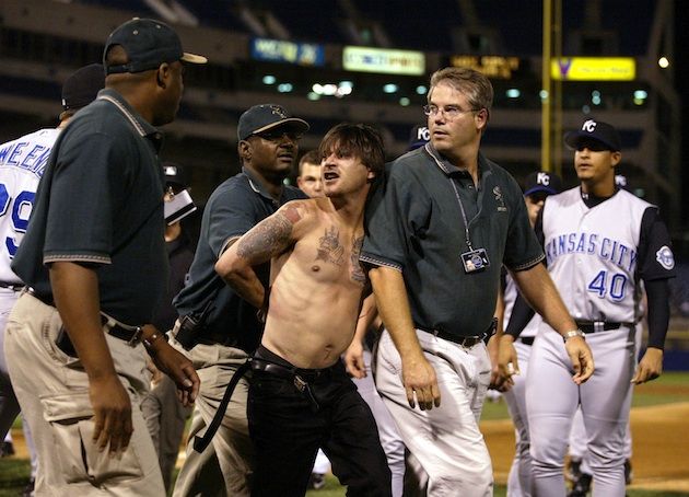 Kansas City Royals coach Tom Gamboa is attacked by two fans