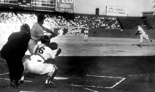 Former pitching prospect Stan Musial throws his only pitch in his 22 year career