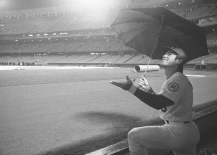 April 12, 1976: Los Angeles Dodgers first baseman Steve Garvey shields his head with an umbrella while watching rain fall at Dodger Stadium. After a 75-minute delay, the scheduled home opener was postponed. (Joe Kennedy / Los Angeles Times Archive/UCLA)