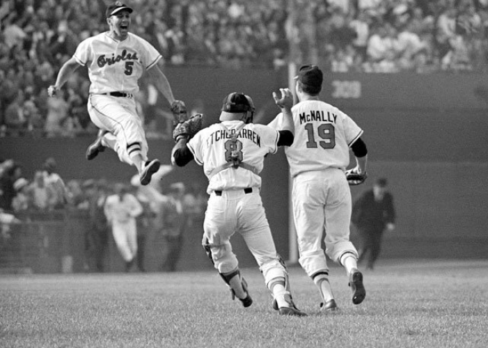 Brooks Robinson leaps for joy with teammates Dave McNally and Andy Etchebarren after the Orioles swept the Dodgers in four games in the 1966 World Series.