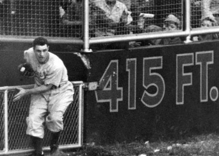 Al Gionfriddo of the Brooklyn Dodgers makes a game-saving catch against Joe DiMaggio of the New York Yankees in the sixth game of the World Series