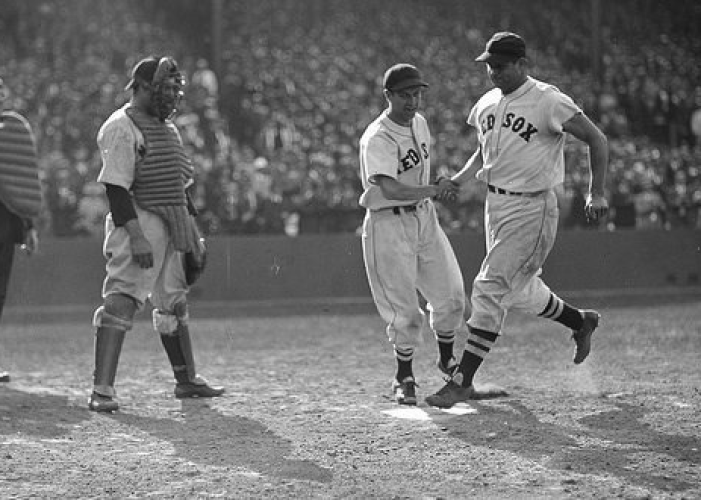 Jimmie Foxx touching home plate after hitting a home run at Fenway Park.