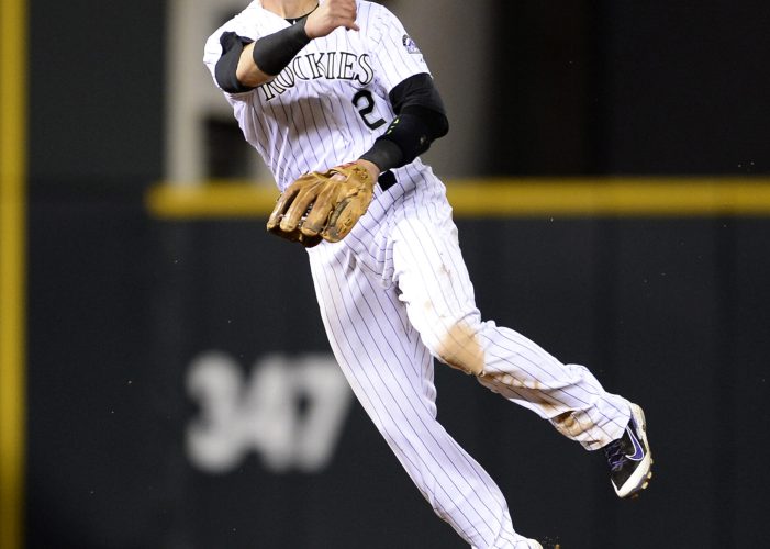 Jun 24, 2015; Denver, CO, USA; Colorado Rockies shortstop Troy Tulowitzki (2) throws back to first base in the eighth inning against the Arizona Diamondbacks at Coors Field. The Diamondbacks defeated the Rockies 8-7. Mandatory Credit: Ron Chenoy-USA TODAY Sports